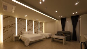 A modern hotel room with two beds, a sofa, a coffee table, and marble walls. - Hotel Browndot Chungjang (Gwangju)