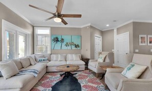 A living room with a sectional sofa, a coffee table, and a ceiling fan. - 1-Min Walk to Private Beach | Family-Friendly Escape (Miramar Beach)