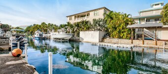 Canalside condo with private dock, boat ramp, water-view patio, central AC & W/D