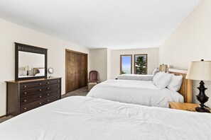 A bedroom with two beds, a dresser, a chair, and a window with a view. - 9 Min to Lutsen MTN/Sauna/Game Rm/Amazing Views (Tofte)
