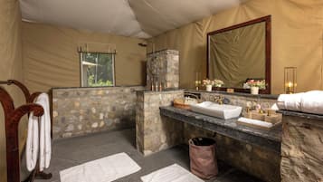 Bathroom features a large mirror above the sink and a wooden towel rack.