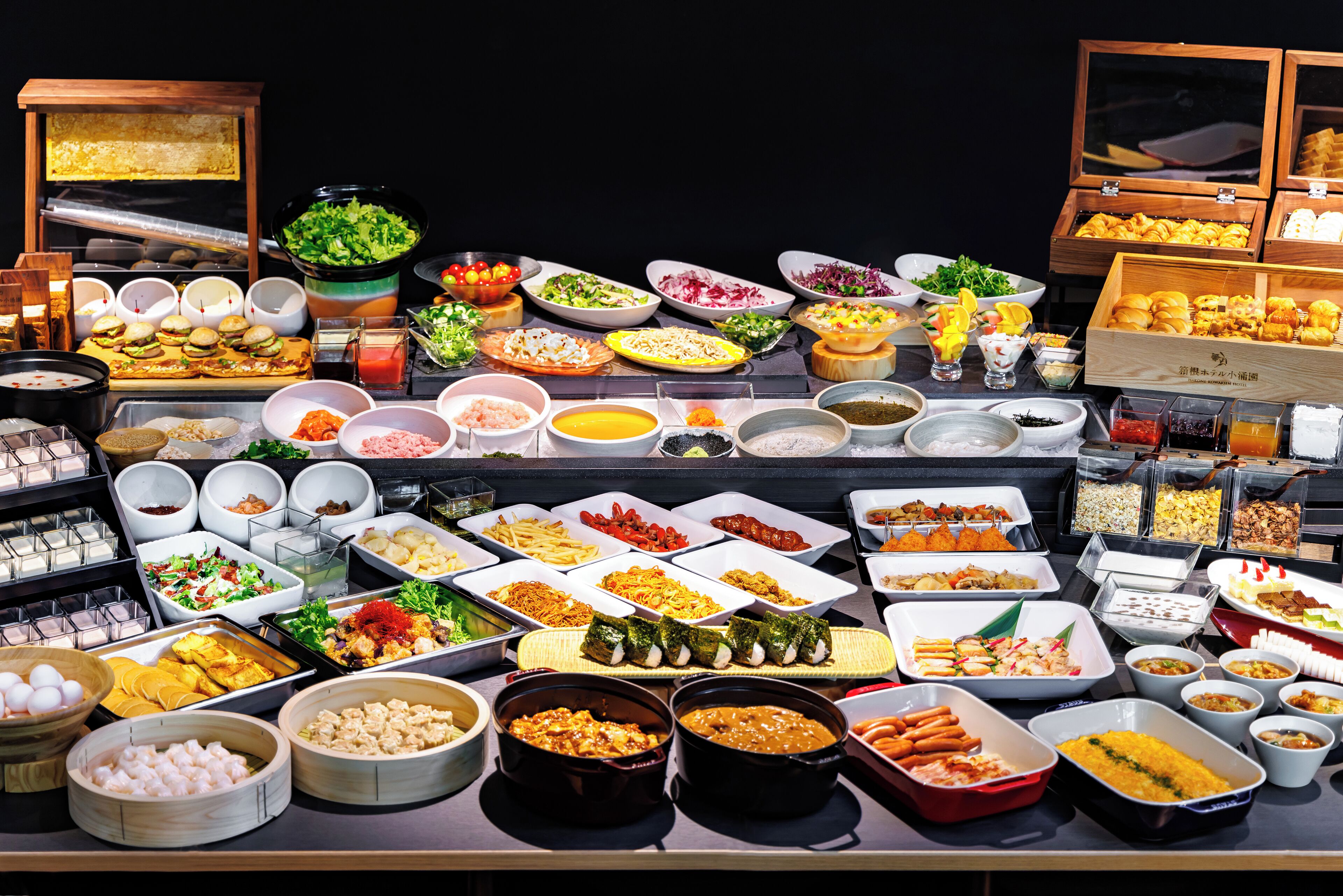 A buffet with various dishes and food items.