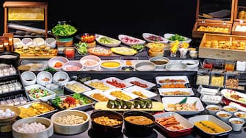 A buffet with various dishes and food items.