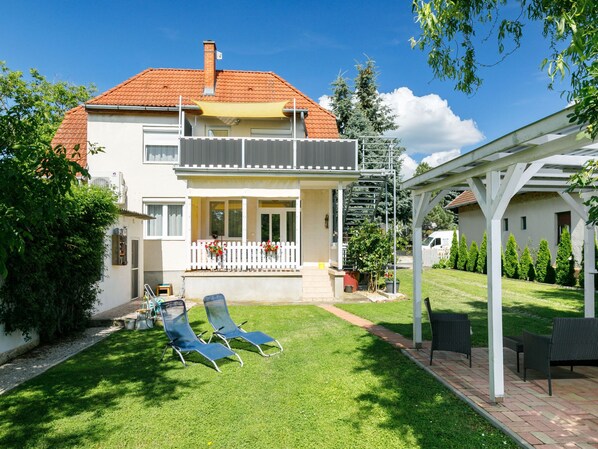 Enjoy a relaxing stay in this charming two-story home with a covered patio and outdoor seating area.