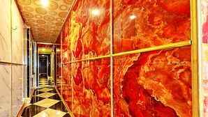 A luxurious hallway with a checkered floor, marble walls, and a patterned ceiling. - HANZ CK Saigon Central Hotel (Ho Chi Minh City)