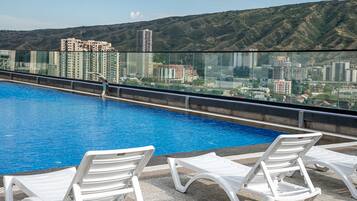 Seasonal outdoor pool, open 10:00 AM to 9:00 PM, pool umbrellas