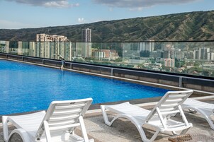 Seasonal outdoor pool, open 10:00 AM to 9:00 PM, pool umbrellas