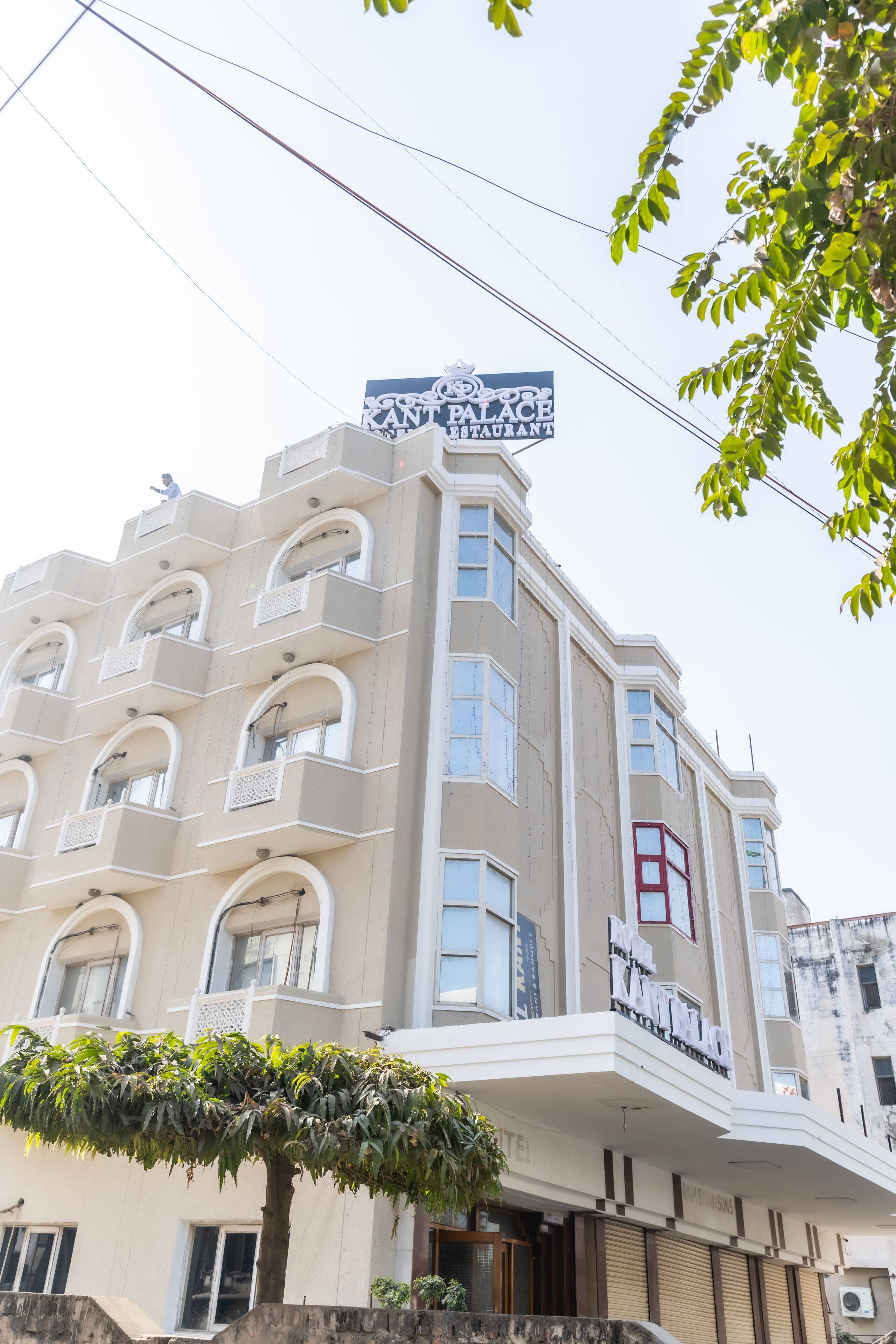 A multi-story building with a prominent sign for "Palace Restaurant" on the top.