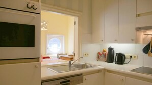 A modern kitchen with a built-in dishwasher, a sink, and a stove.