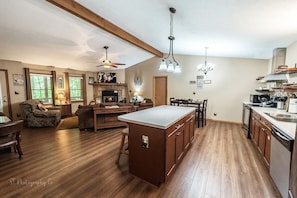 Enjoy cooking in the well-equipped kitchen with a central island and dining area, perfect for meals with family and friends.