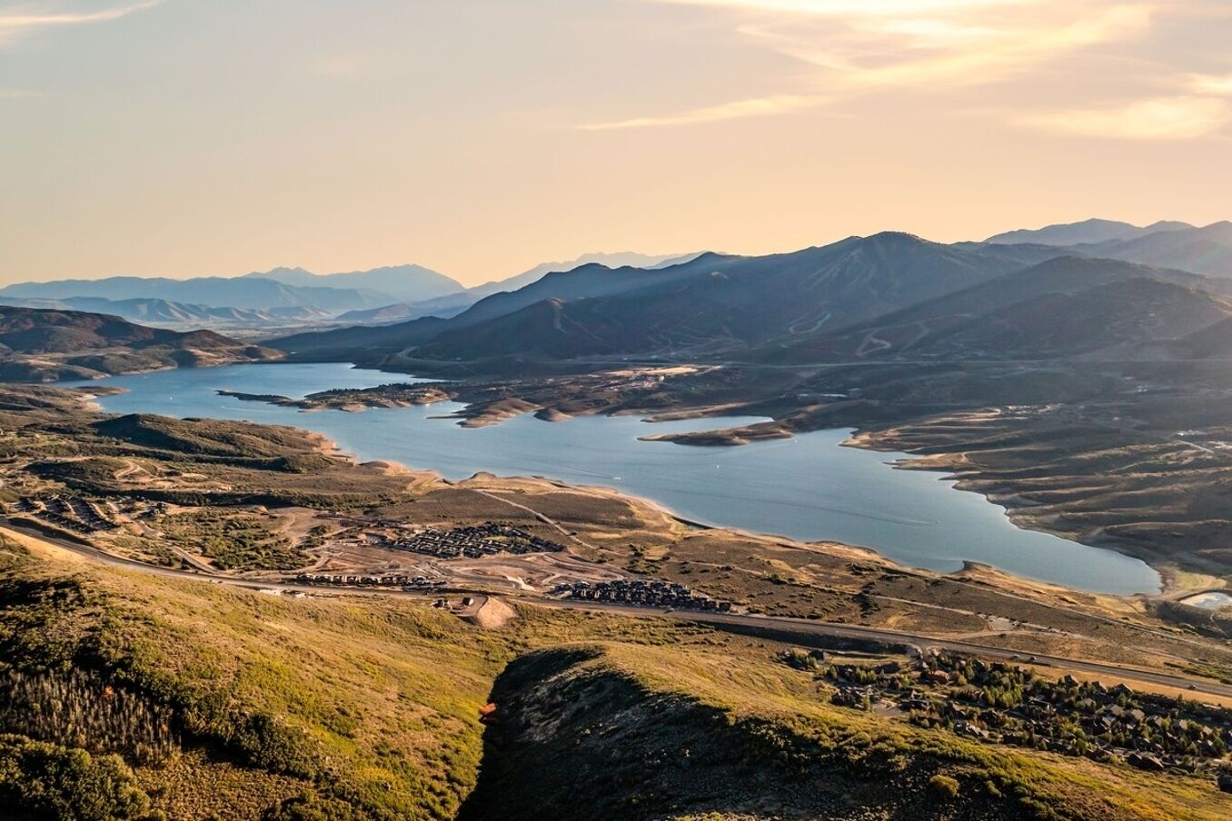 A mountainous landscape with a river, roads, and scattered buildings.