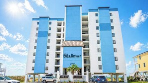 A multi-story hotel with a blue and white facade, balconies, and a sign reading 'Shalimar 2908'.