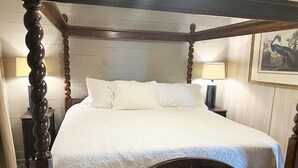 A four-poster bed with a wooden frame and white bedding. - Humble Heaven - Beachfront - Island Realty (Grand Isle)