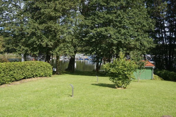 Enjoy a serene lakeside retreat surrounded by lush trees and a tranquil body of water.
