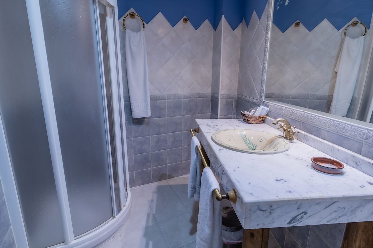 A bathroom with a marble sink, a bathtub, and a shower.