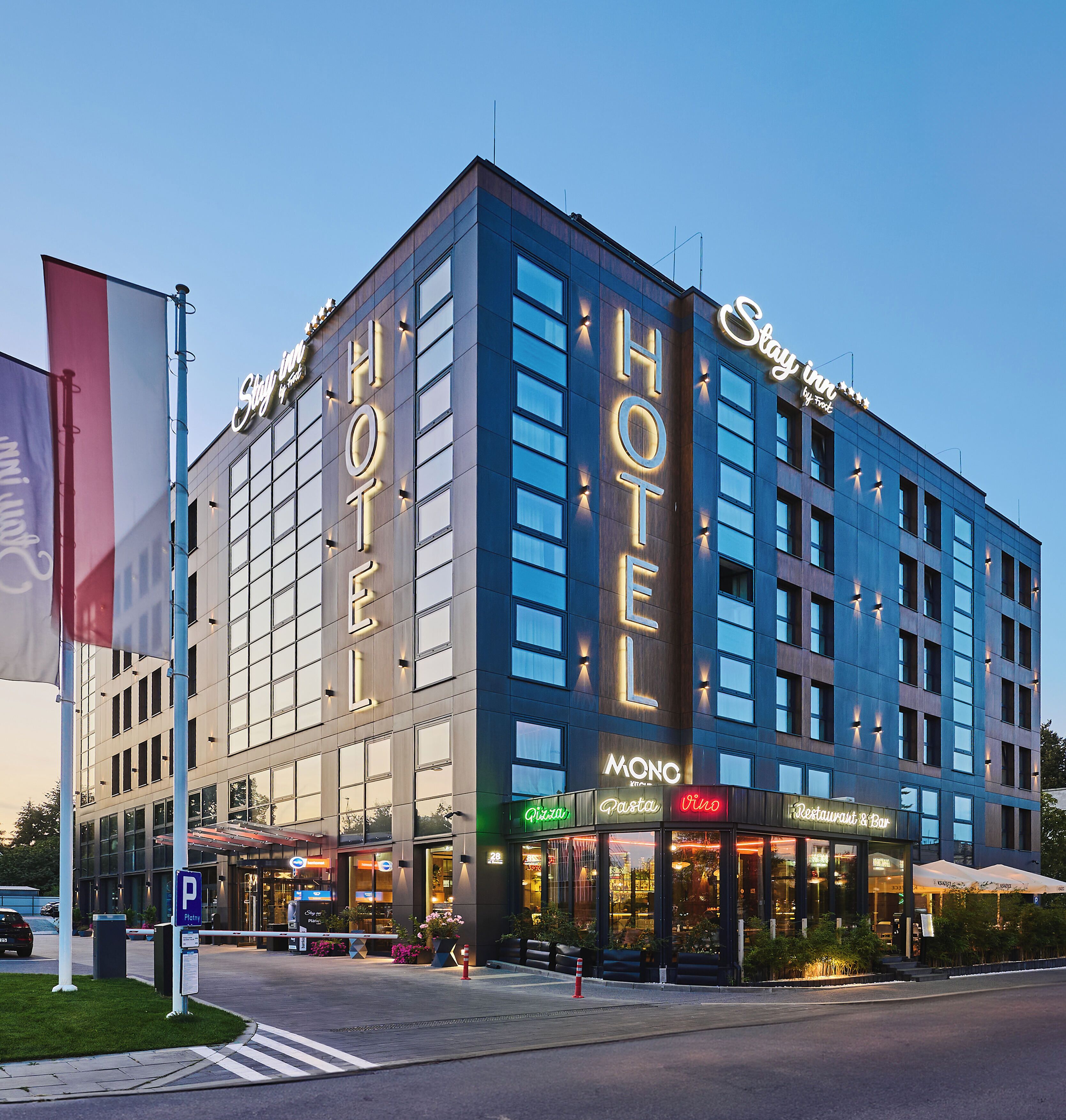 A hotel with a prominent 'HOTEL' sign, a 'Polo' restaurant, and a 'Pasta' restaurant.