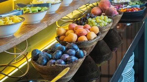 A buffet with various fruits and vegetables arranged in bowls and baskets. - Stay inn Hotel Warszawa  (Warsaw)