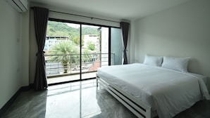 A bedroom with a large window, a bed, and an air conditioning unit. - KOKO Hostel- Adults Only  (Krabi)