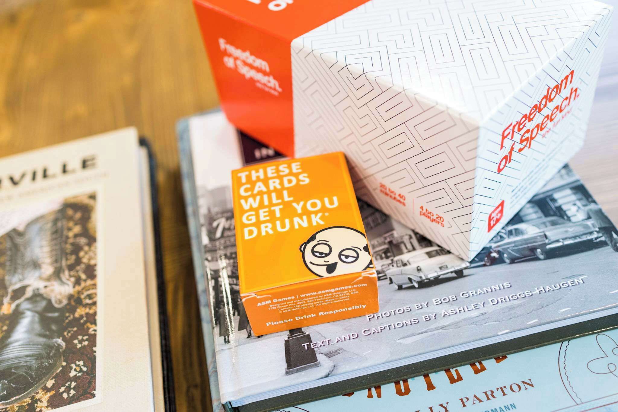 A book titled 'Freedom of Speech' by Bob Grannis and Ashley Driggs-Haugen, with a card on top stating 'These cards will get you drunk'.