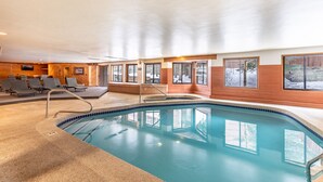 An indoor swimming pool with a clear view of the surrounding area, including a seating area with chairs and a wooden wall. - Private Balcony + Grill, Walk to Mountain House Base Area, Shared Hot Tub (Keystone)