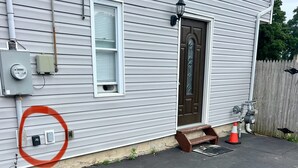 A residential house with a front door, a window, and a garage door. - 1 bedroom 1 bath private entrance (Bay Shore)