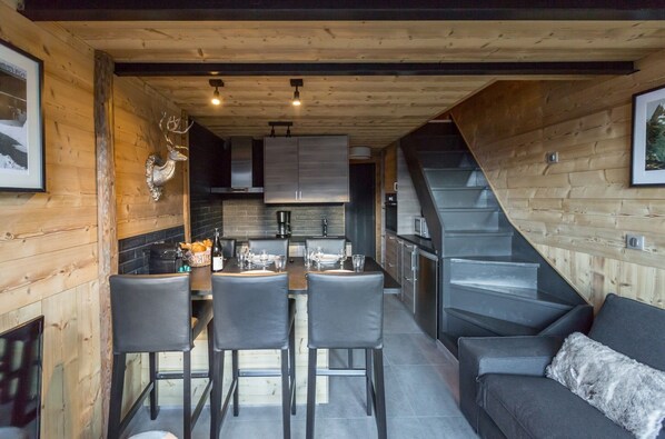Cozy dining area with a wooden table and four chairs, perfect for family meals.