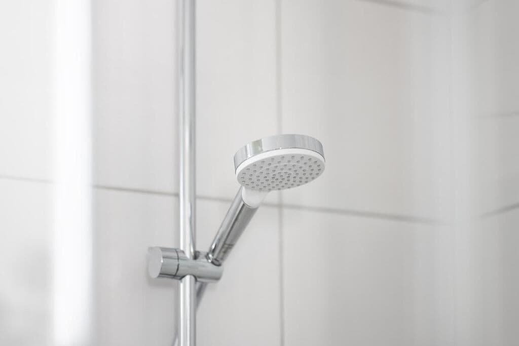 A showerhead with a circular design and a single-handle control.