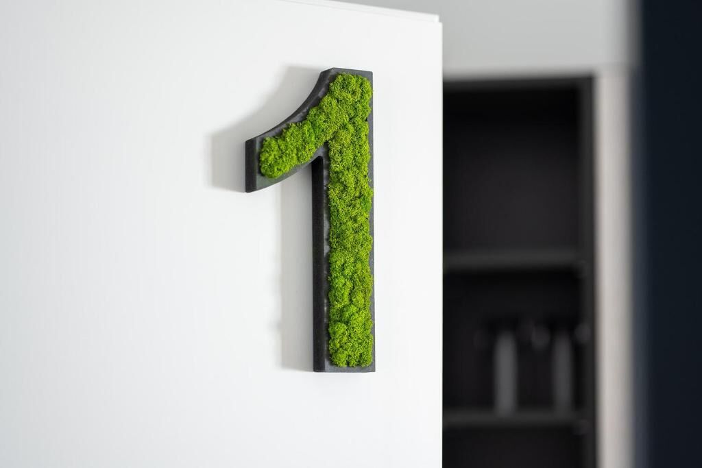 A wall-mounted number '1' with a textured surface.