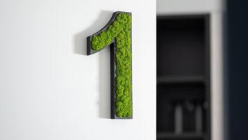 A wall-mounted number '1' with a textured surface.