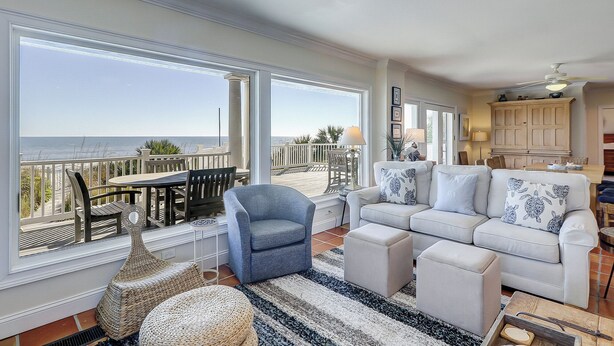 A spacious living area with a balcony overlooking the sea, a dining area, and a kitchen. - 20 Ibis -Oceanfront, 7 Bedroom home w/ private pool.  Sleeps 19 (Hilton Head Island)