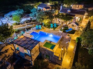 An aerial view of a property with a swimming pool, outdoor seating, and a covered area. - Gabelot (Supetar)