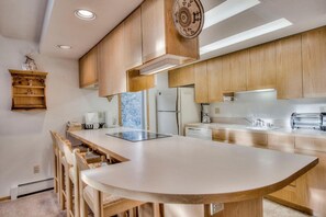 Enjoy cooking in this well-equipped kitchen with a central island and bar seating.