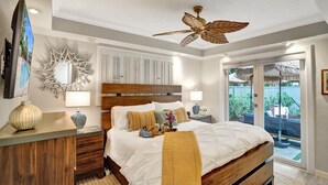 A bedroom with a wooden bed, a ceiling fan, and a view of the outdoors. - By Pier- Heated Pool- 5 Stars! Marbella (Fort Lauderdale)