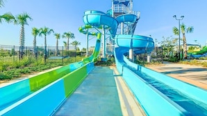 A water park with multiple water slides and a central tower structure.