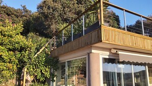 A two-story building with a balcony, surrounded by lush greenery and trees. - Villa Anchorage, SEA VIEW, HEATED POOL , no vis-a-vis (PORTO VECCHIO)