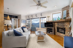 Get cozy in the chic living room around the gas logs fireplace to stream binge-worthy shows on the Smart TV while taking in the mountain views from the window. - Hot Tub, Fire Pit & Mountain Views — Near Hiking Trails in Hickory Nut Gorge! (Hendersonville)