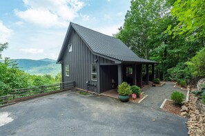 Paved parking area alongside the house. - Hot Tub, Fire Pit & Mountain Views — Near Hiking Trails in Hickory Nut Gorge! (Hendersonville)