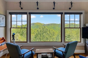 Main floor sitting area with gorgeous mountain views. - Hot Tub, Fire Pit & Mountain Views — Near Hiking Trails in Hickory Nut Gorge! (Hendersonville)