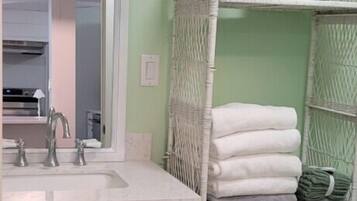 Bathtub, hair dryer, towels, toilet paper