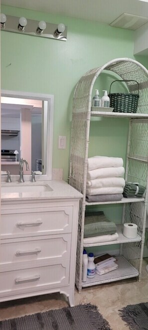 Bathtub, hair dryer, towels, toilet paper