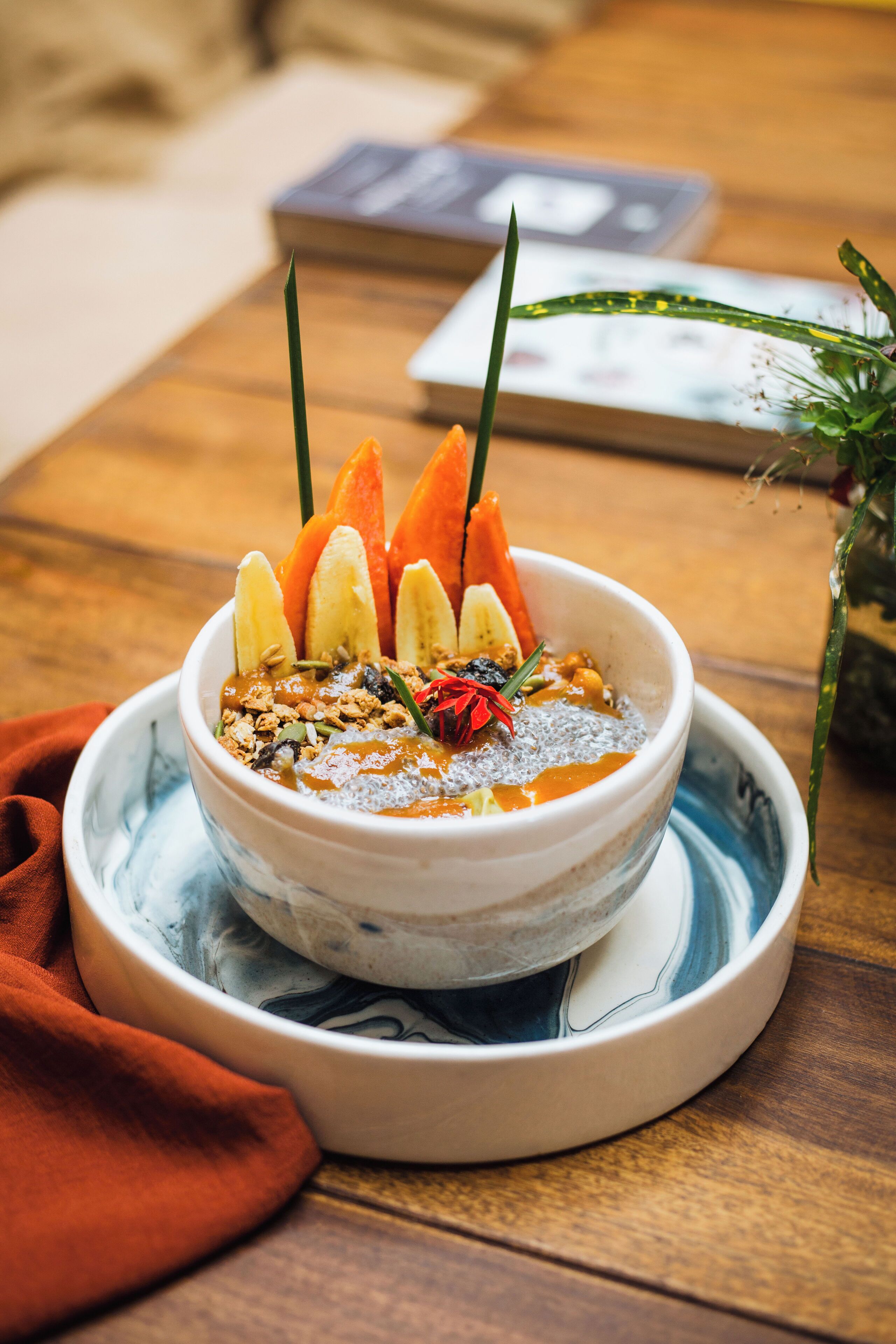 Un tazón de comida con diversas frutas y ingredientes sobre una mesa de madera.