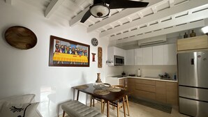 A modern kitchen with white cabinetry, a stainless steel refrigerator, and a ceiling fan. - OLD MOON OLD SAN JUAN (San Juan)