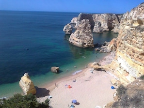A coastal beach with rocky cliffs and clear blue waters. - Traditional Charm 4 bedroom villa in Vilamoura: Pool, AC & Full Wi-Fi (Vilamoura)