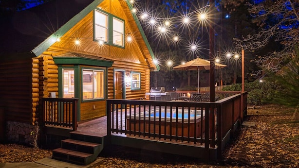A log cabin with a deck, a hot tub, and string lights. - Bear Kub Kabin + Games + 1 Block to Snow Summit! (Big Bear Lake)