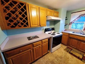 Enjoy cooking in this well-equipped kitchen with a stove, window, and ample counter space.