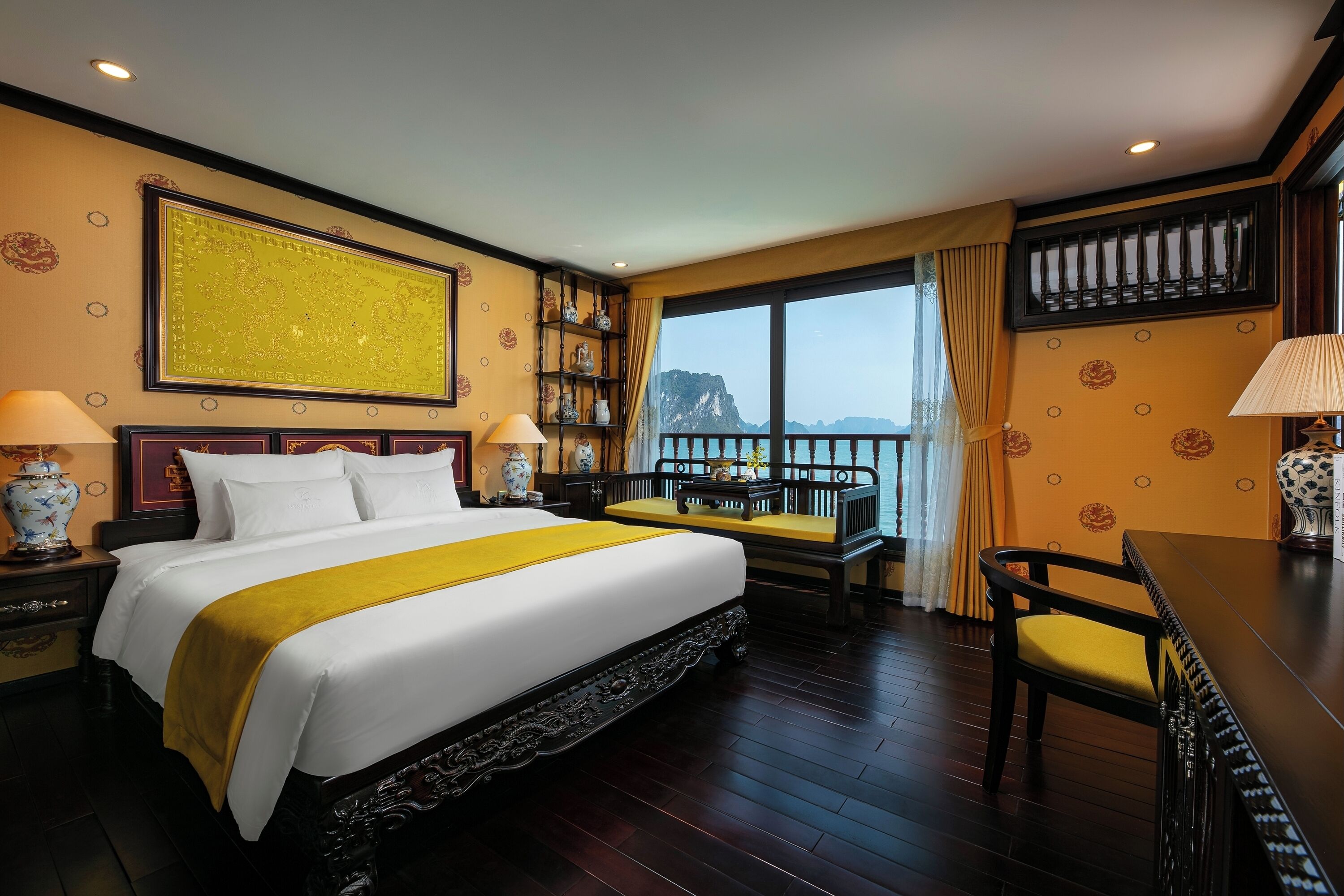 A hotel room with a large bed, a balcony with a view, and traditional decor.
