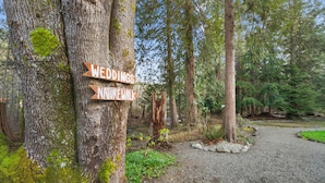 A natural setting with a sign indicating a wedding venue and a nearby nature walk. - Cabin #5 (Union)