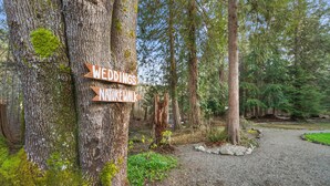 A natural setting with a sign indicating a wedding venue and a nearby nature walk. - Hot Tub Cabin #15 (Union)