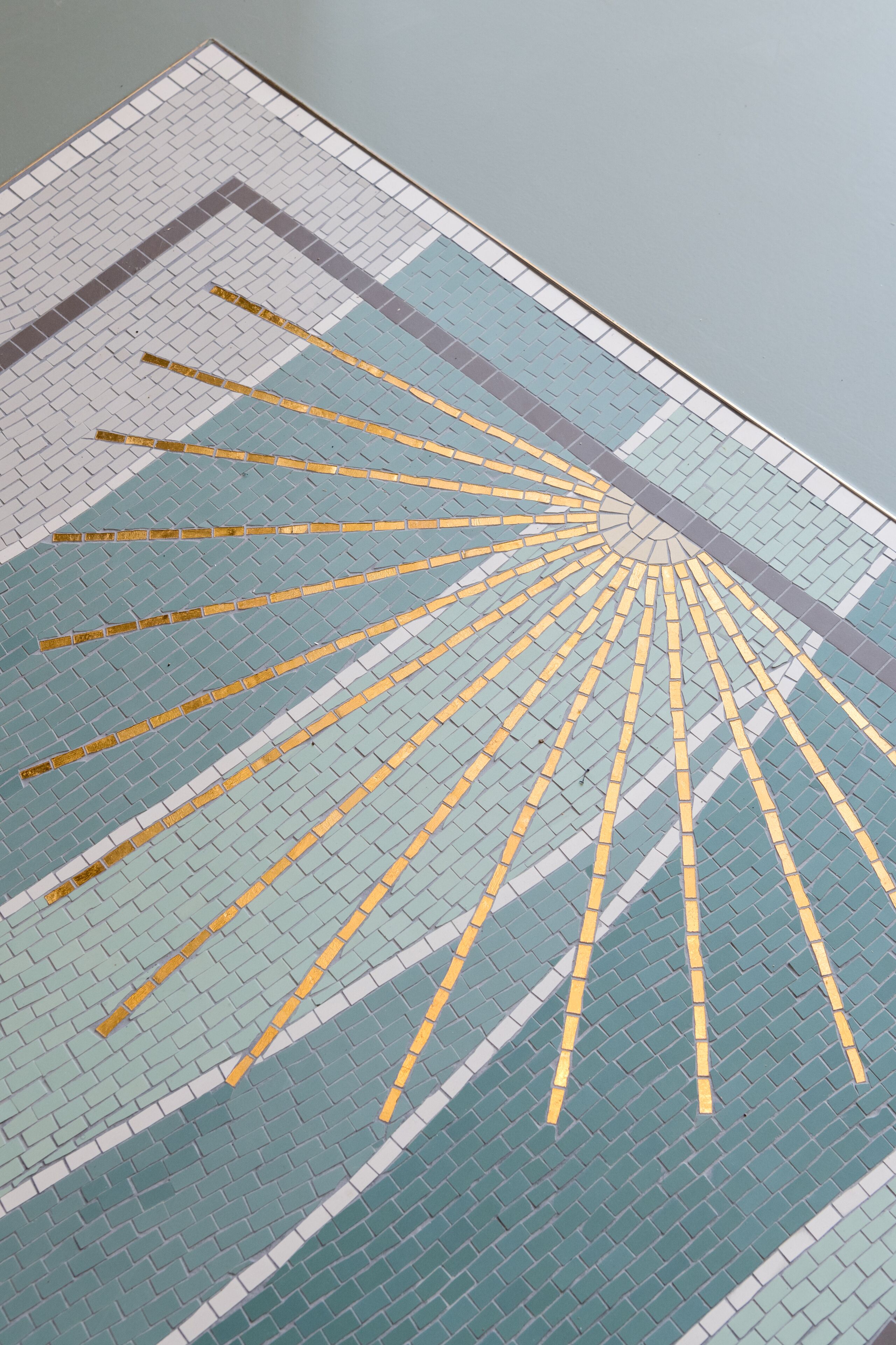 A tiled floor with a radial pattern of yellow lines.