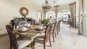 A formal dining room with a long table set for six, surrounded by upholstered chairs. - Wild Cane Ridge 2 by Island Villas (Westmoreland)